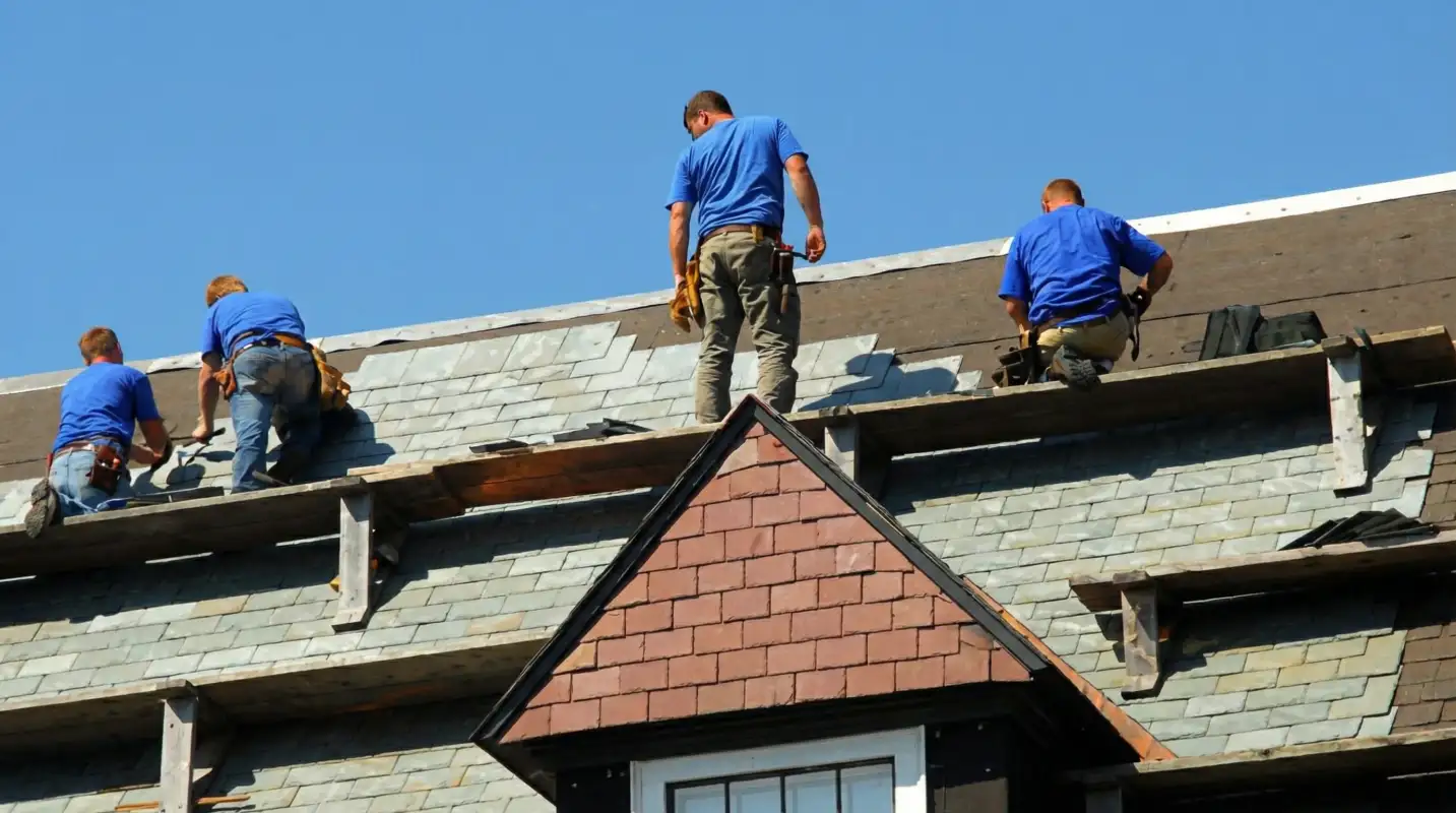 Roof replacement in progress with a team of professional contractors installing new shingles on a residential home in Shreveport, LA